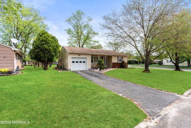 ranch-style home with an attached garage, driveway, and a front yard