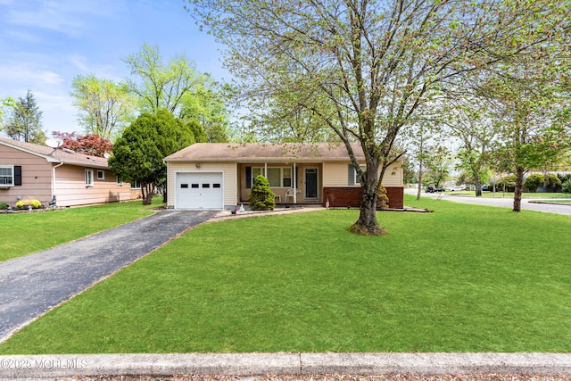 ranch-style house featuring a garage, driveway, and a front yard