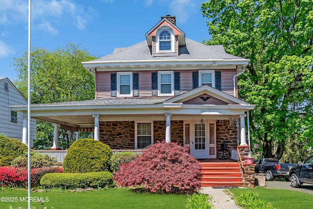 125 W Main St, Freehold, NJ 07728 - view of front of house with covered porch, a front yard, stone siding, roof with shingles, and a chimney