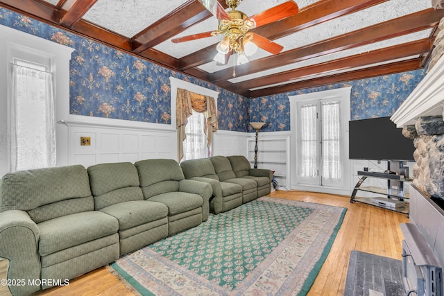 125 W Main St, Freehold, NJ 07728 - living room with wood-type flooring, wainscoting, beamed ceiling, ceiling fan, and wallpapered walls