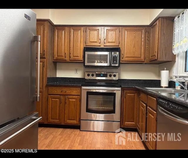 655 Yale Way Unit A, Monroe, NJ 08831 - kitchen with stainless steel appliances, a sink, brown cabinets, and dark countertops
