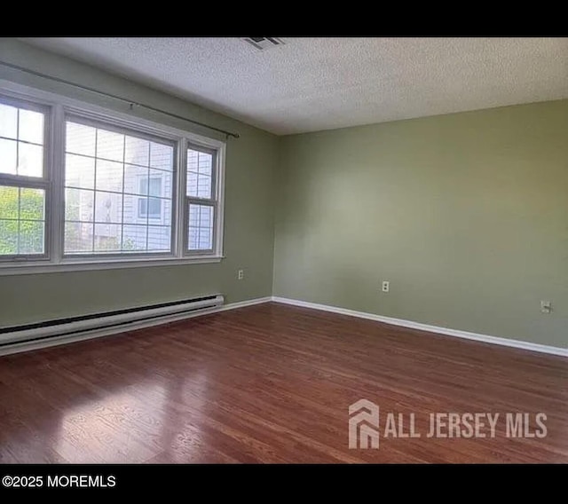 655 Yale Way Unit A, Monroe, NJ 08831 - unfurnished room featuring a baseboard heating unit, wood finished floors, baseboards, and a textured ceiling