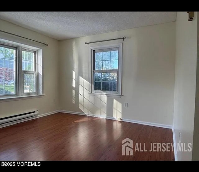 655 Yale Way Unit A, Monroe, NJ 08831 - empty room featuring wood finished floors, a textured ceiling, baseboards, and baseboard heating