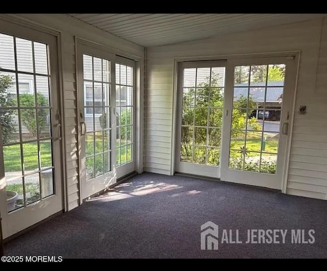 655 Yale Way Unit A, Monroe, NJ 08831 - doorway to outside with carpet flooring, healthy amount of natural light, and wooden walls