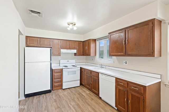8 Constable St, Brick, NJ 08724 - kitchen with white appliances, brown cabinets, light wood-style floors, and light countertops
