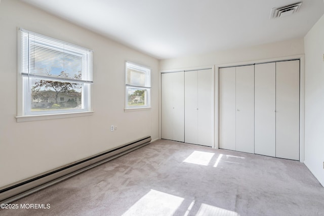 8 Constable St, Brick, NJ 08724 - unfurnished bedroom featuring a baseboard radiator, multiple closets, and carpet