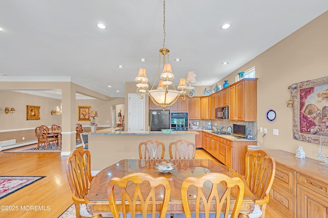 dining area featuring crown molding, recessed lighting, a chandelier, and light wood finished floors
