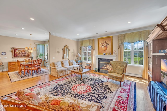 living area with plenty of natural light, a fireplace with flush hearth, a baseboard radiator, and wood finished floors