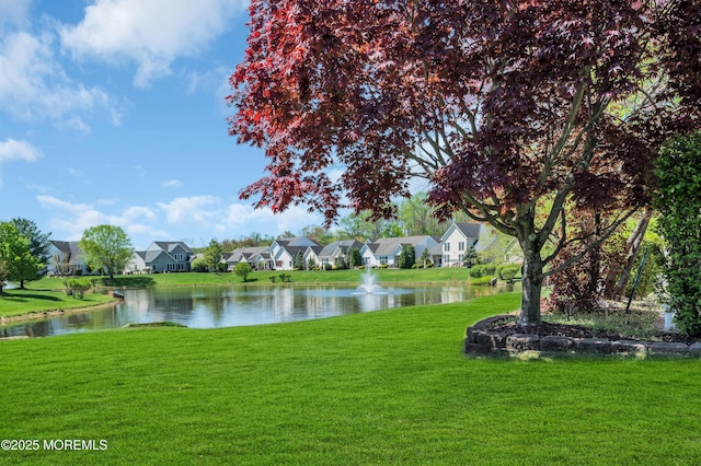 surrounding community featuring a lawn, a water view, and a residential view
