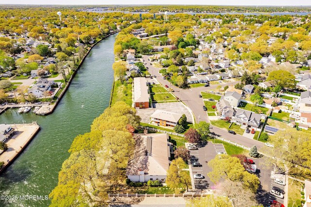 drone / aerial view with a residential view and a water view