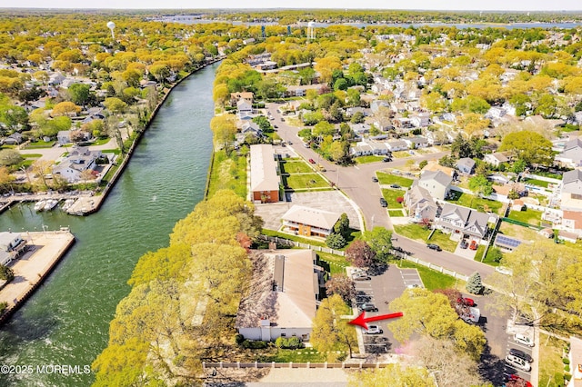 birds eye view of property with a water view and a residential view