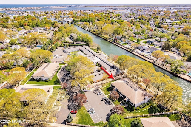 drone / aerial view with a water view and a residential view