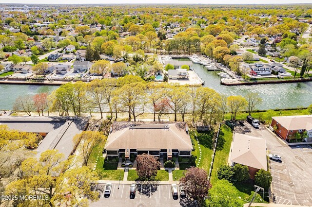 birds eye view of property featuring a water view and a residential view