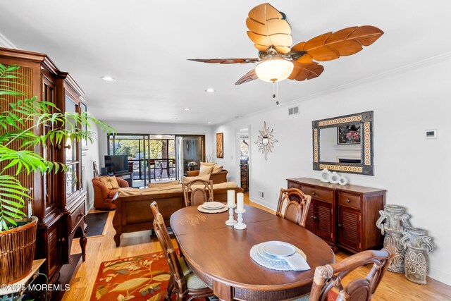 dining room with a ceiling fan, visible vents, ornamental molding, recessed lighting, and light wood-style flooring