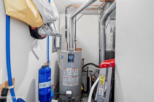 utility room featuring water heater and electric panel