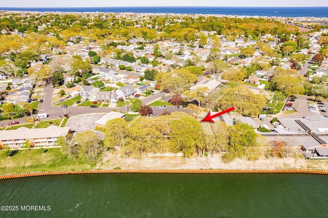 drone / aerial view with a water view and a residential view