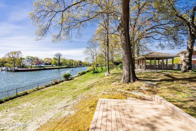 view of yard with a water view, a gazebo, and fence