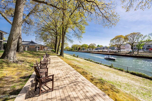property view of water featuring fence and a residential view