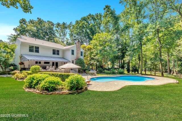 pool with a patio and a yard