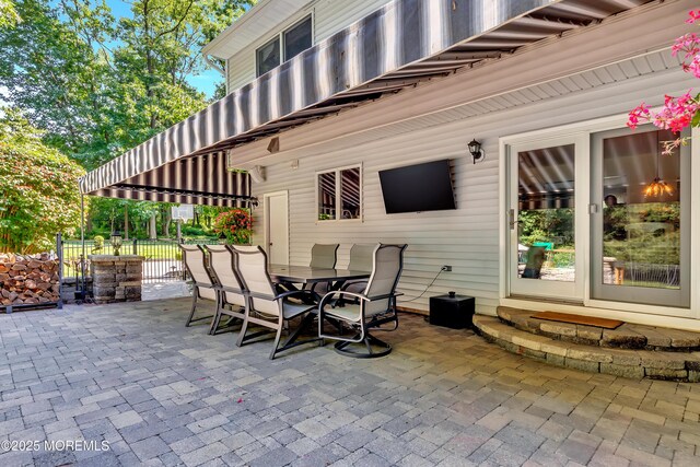 view of patio / terrace featuring outdoor dining area and fence