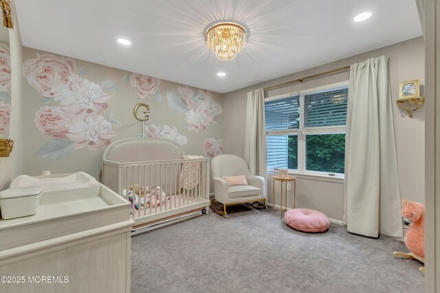 bedroom featuring a nursery area, carpet flooring, recessed lighting, and a chandelier