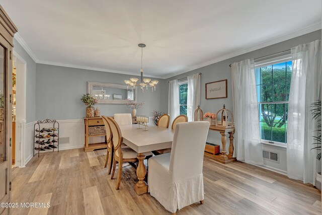 dining area featuring an inviting chandelier, light wood-type flooring, and a healthy amount of sunlight