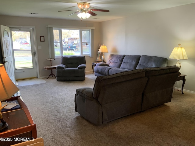 carpeted living room with visible vents, baseboards, and ceiling fan