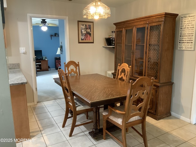 dining area with baseboards, ceiling fan, and light tile patterned floors