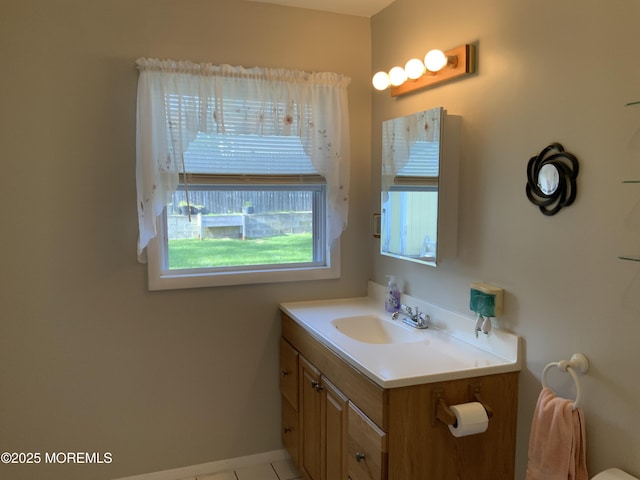 bathroom featuring vanity, tile patterned flooring, and baseboards