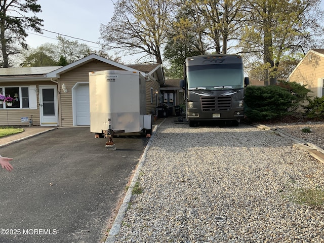 exterior space with solar panels and driveway