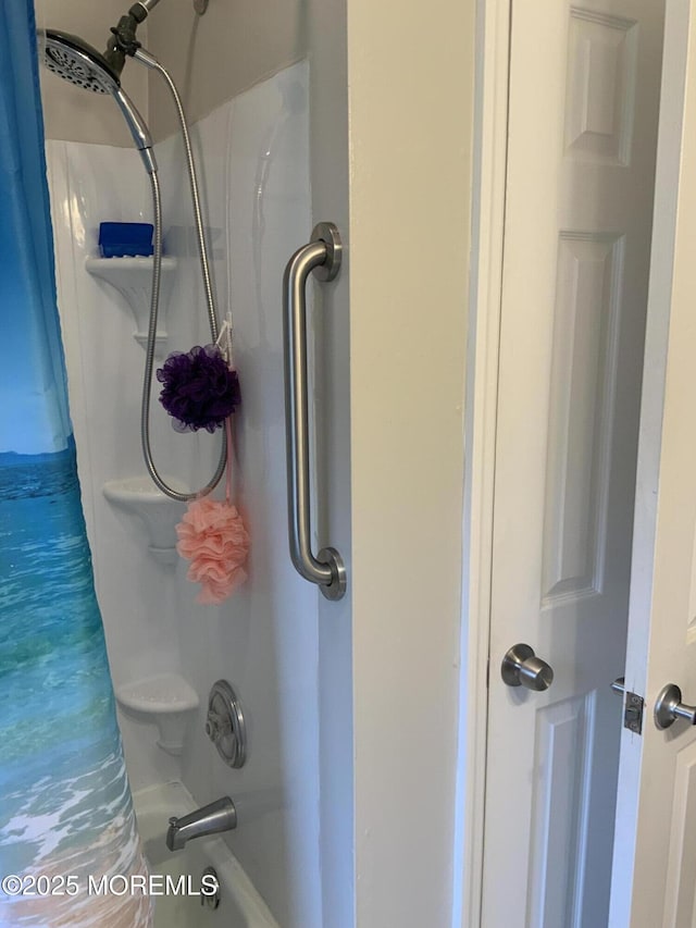 interior details featuring shower / bath combo