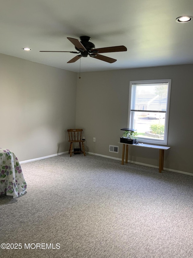 spare room featuring carpet floors, recessed lighting, ceiling fan, and visible vents