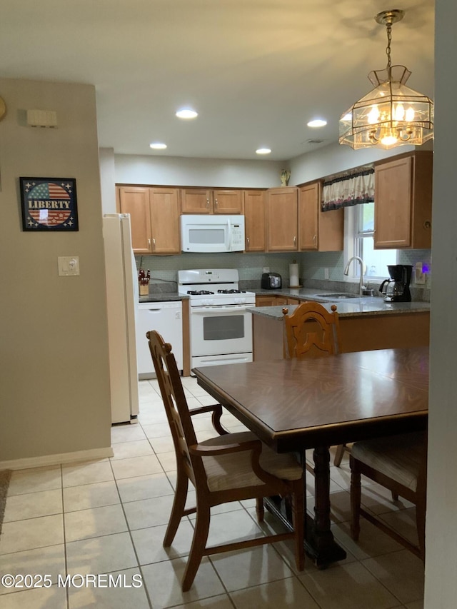 kitchen with brown cabinets, a sink, white appliances, a chandelier, and decorative light fixtures