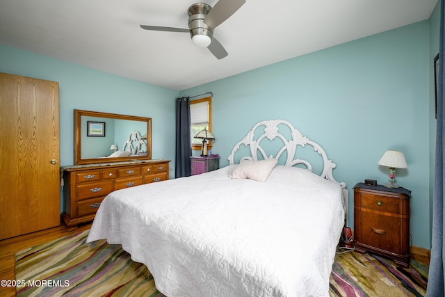 bedroom featuring ceiling fan and wood finished floors