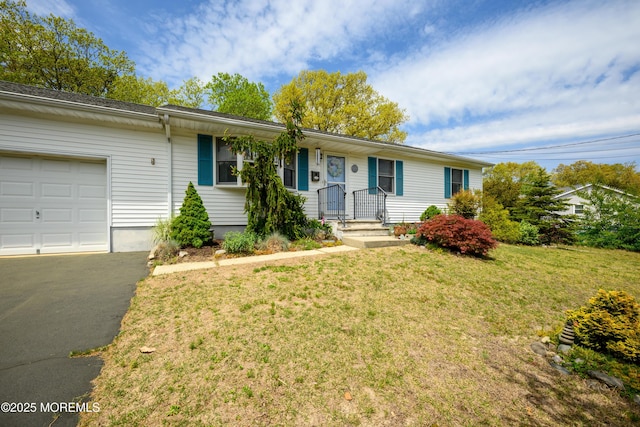 ranch-style home with an attached garage, a front yard, and aphalt driveway