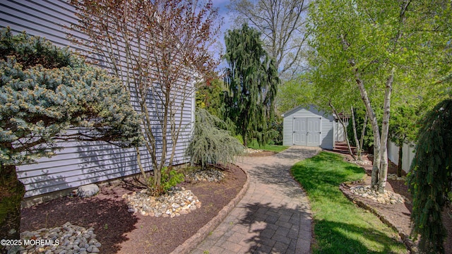 view of yard featuring a shed and an outbuilding