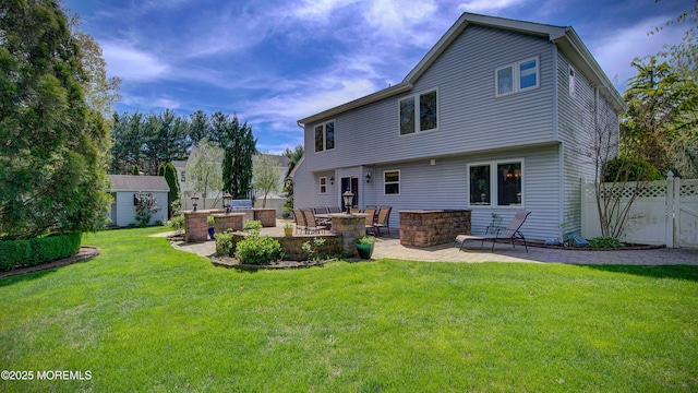 rear view of house featuring a patio area, exterior kitchen, a yard, and fence