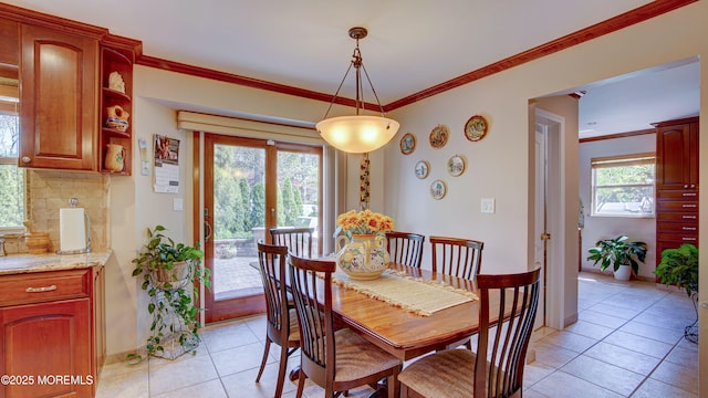 dining space featuring baseboards, french doors, ornamental molding, and light tile patterned floors