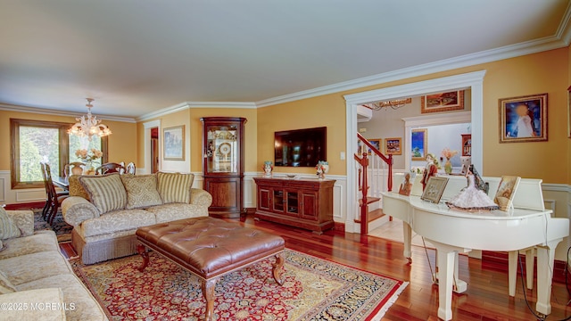 living room with crown molding, stairway, hardwood / wood-style floors, and a notable chandelier