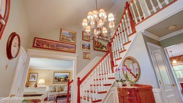 staircase with crown molding, a notable chandelier, and a towering ceiling