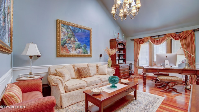 living room featuring an inviting chandelier, high vaulted ceiling, and wood finished floors