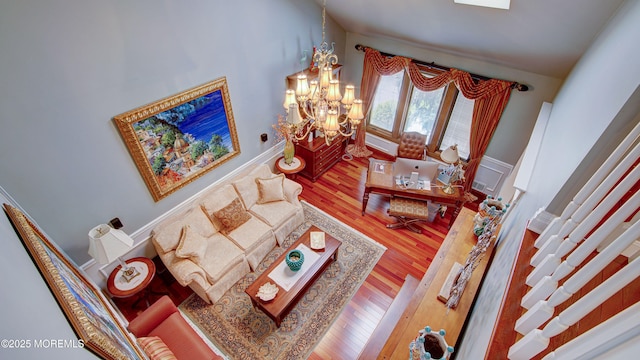 living room with an inviting chandelier and wood finished floors