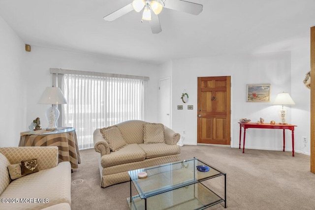 carpeted living room with baseboards and ceiling fan