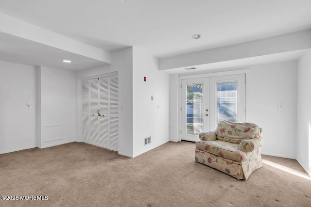 sitting room with recessed lighting, baseboards, light carpet, and french doors