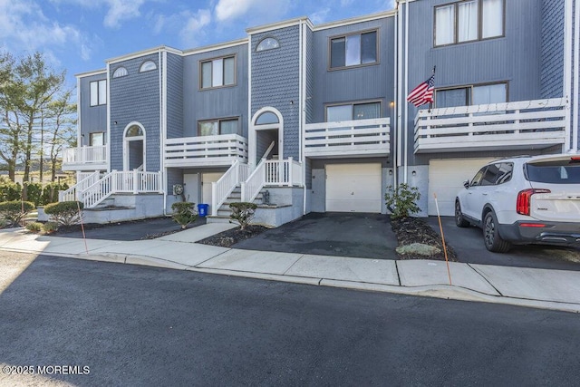 townhome / multi-family property featuring driveway and a garage