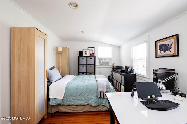 bedroom with ornamental molding, cooling unit, wood finished floors, and lofted ceiling