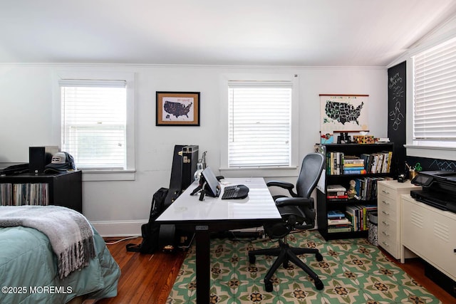 bedroom featuring baseboards, ornamental molding, and wood finished floors