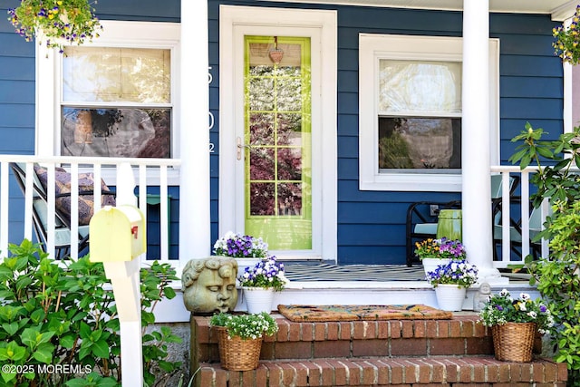 doorway to property featuring covered porch