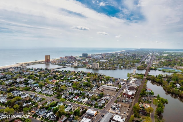 birds eye view of property with a city view and a water view