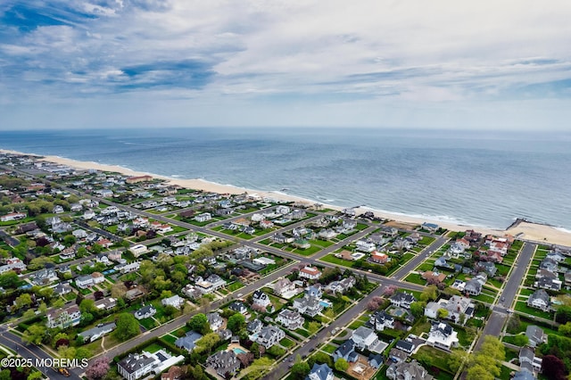 aerial view with a water view, a view of the beach, and a residential view